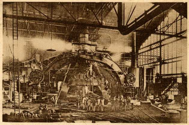 Ein Schwarz-Weiß-Foto einer Fabrikszene bei Cadillac Steel Works, bei der Arbeiter eine große Maschine bedienen, umgeben von Leitern und Stangen.