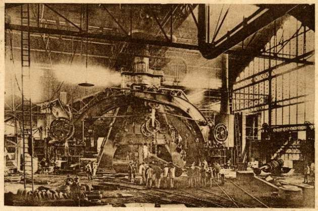 Schwarz-weiß-Foto eines Fabrikinneren mit Arbeitern, die an einer großen Maschine arbeiten, umgeben von Leitern, Stangen und Equipment, mit dem Text "Cadillac Steel Works" unten.