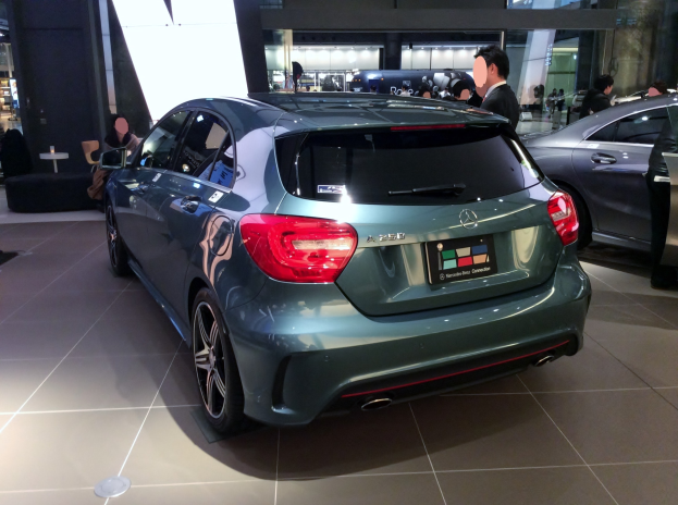 Ein Mercedes-Benz A-Klasse Hatchback auf der Frankfurter Motor Show, glänzend schwarz mit Chromakzenten, niedriger Profil, breite Standfläche, markantes Grill und Aluminiumräder, umgeben von Menschen.